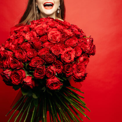 Selective Focus Of Bouquet Of Red Roses In Hands Of Woman